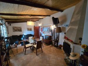 a living room with a table and a fireplace at Casa da Minha Avó in São Pedro de Solis