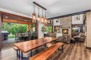 a living room with a wooden table and a fireplace at Cabin at the Crest in Ronald