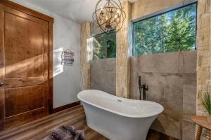 a bathroom with a tub and a window at Cabin at the Crest in Ronald +49 photos