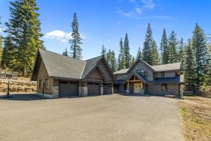 a large house with a driveway in a forest at Cabin at the Crest in Ronald