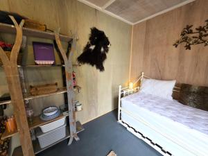 a bedroom with two bunk beds and a desk at The Hideaway Pod in Chelmsford