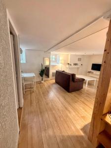 a living room with a couch and a table at Le Spa des Laurières in Bagnères-de-Bigorre