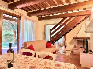 a living room with a table and a couch at Ville Di Villa Biserno in San Vincenzo