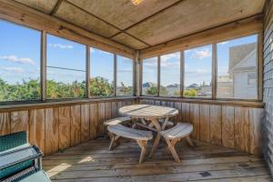 a screened porch with a table and two chairs at 7834 - Royal - T in Frisco +40 photos