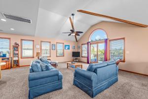 a living room with two blue chairs and a ceiling fan at 7834 - Royal - T in Frisco
