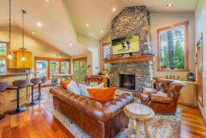 a living room with a couch and a stone fireplace at 7th Heaven in Cle Elum