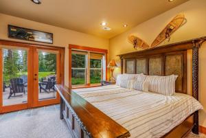 a bedroom with a large bed with a wooden headboard at 7th Heaven in Cle Elum