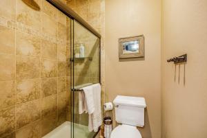 a bathroom with a toilet and a glass shower at 7th Heaven in Cle Elum +42 photos