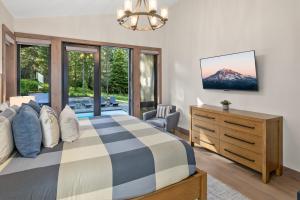 a bedroom with a bed and a dresser and a window at Whispering Woodland in Cle Elum +57 photos