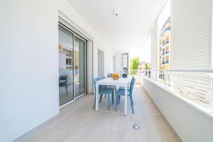 a white table and chairs on a balcony at Camilla al mare in Tortoreto Lido