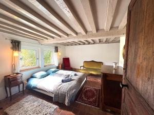 a bedroom with a bed and a wooden ceiling at Maison XVIIIe avec vue panoramique exceptionnelle - 12 pers au coeur du Pays d'Auge in Le Renouard