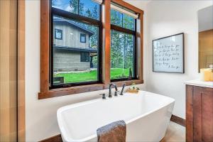 a large white tub in a bathroom with a window at Par 6 Lodge in Cle Elum +55 photos
