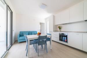 a kitchen and dining room with a table and chairs at Camilla al mare in Tortoreto Lido +21 photos