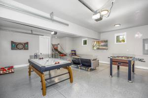 a living room with two ping pong tables and a couch at Casa Mia in Cle Elum