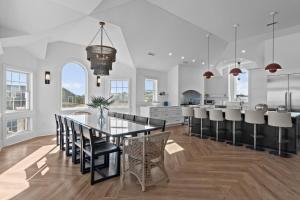 a dining room and kitchen with a table and chairs at 2876 - The Blue Martini in Duck