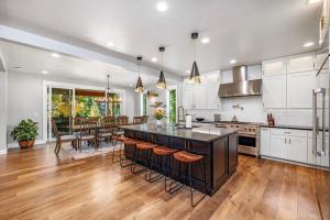 a kitchen with white cabinets and a large island with bar stools at Four Seasons Lodge in Cle Elum