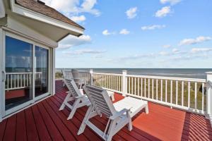 a porch with white chairs and the ocean at 4099 - 3-2-1 Relax in Duck