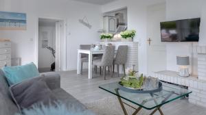 a living room with a couch and a table at Ferienhaus Weitblick in Morsum