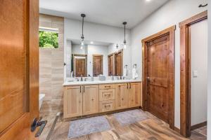 a bathroom with two sinks and a wooden door at Three Pines in Cle Elum +45 photos