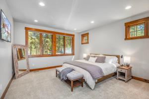 a bedroom with a bed and a chair and windows at Suncadia Craftsman in Cle Elum +47 photos