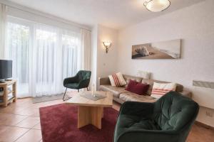 a living room with a couch and a chair at Fewo Lee in Kühlungsborn