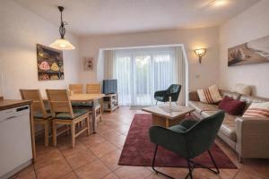 a living room with a couch and a table at Fewo Lee in Kühlungsborn