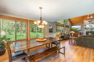 a dining room with a table and a couch at Playground in the Pines in Ronald