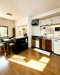 a kitchen with a sink and a table in it at 海の風-春 in Wakayama