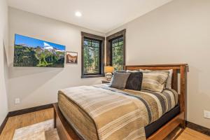 a bedroom with a bed and two windows at Idol Pines in Cle Elum
