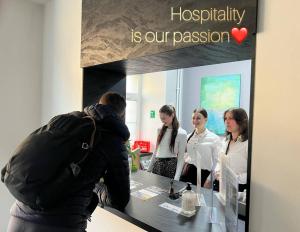 a group of people standing around a counter in a store at FOKA Hostel in Wrocław