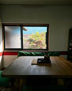 a wooden table in a room with a window at 海の風-春 in Wakayama