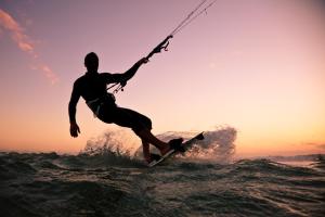a man riding a wave on a surfboard in the water at Seehütte 004 in Cuxhaven