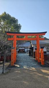 an orange torii gate in front of a building at 海の風-春 in Wakayama