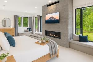 a bedroom with a large bed with a fireplace at Humble House in Cle Elum +76 photos