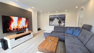 a living room with a couch and a fireplace at Ferienwohnung "Ostseebrise" in Wendtorf in Wendtorf