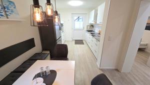 a kitchen and dining room with a table and chairs at Ferienwohnung "Ostseebrise" in Wendtorf in Wendtorf +15 photos
