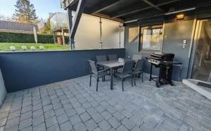 a patio with a table and chairs and a piano at Ferienwohnung "Ostseebrise" in Wendtorf in Wendtorf
