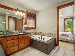 a bathroom with a tub and a sink at Gilden Glade Sanctuary in Cle Elum +51 photos
