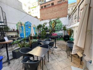 a patio with tables and chairs in a building at Tarragona Hostel in Tarragona