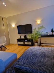 a living room with a flat screen tv on a wall at SelfossCenter flat in Selfoss
