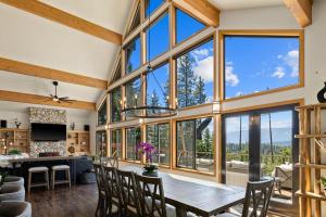 a large dining room with a table and chairs and large windows at Skyline in Roslyn