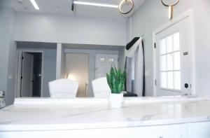 a mirror in a white room with white chairs at West New York room 20 in Guttenberg