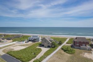 an aerial view of a house and the beach at 2931 - Lighthouse in Duck