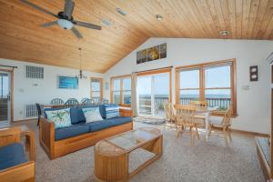 a living room with a couch and a table at 2931 - Lighthouse in Duck +34 photos