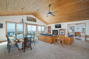 a dining room and living room with a table and chairs at 2931 - Lighthouse in Duck