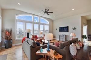 a living room with couches and a large window at 4108 - New Beginnings in Duck