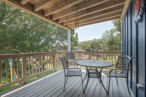 a patio with a table and chairs on a deck at 4620 - Flip Flop Inn in Southern Shores