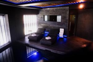 a living room with a couch and blue lights at Cave Hotel & Golf Resort in Faversham +96 photos