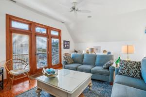 a living room with a couch and a table at 2437 - Sandpiper Station in Duck