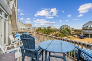 a patio with a table and chairs on a balcony at 2437 - Sandpiper Station in Duck +68 photos